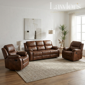 A tan PU leather 3+1+1 sofa set flanked in a bright, modern living room. The furniture is arranged on a textured beige area rug over a wood floor, with a side table, lamps, a potted plant, and abstract wall art in the background.