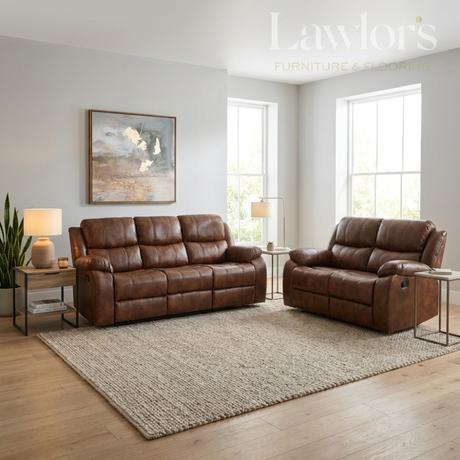 A tan PU leather 3+2 reclining sofa set arranged in a bright living room with wood floors, a large beige rug, side tables, lamps, and wall art.