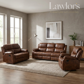 A tan PU leather 3+2+1 reclining sofa set arranged on a light rug in a staged living room. The room has textured gray walls, wood flooring, a floor lamp, and a framed abstract print.