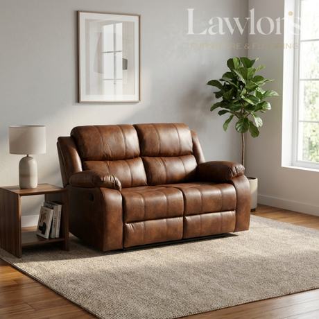 A tan PU leather 2 seater reclining sofa in a bright, modern living room setting with a side table, lamp, potted plant, and window.