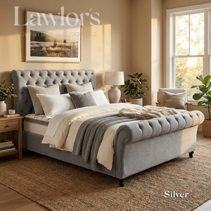 Silver upholstered bed and mattress in a well-lit bedroom bed pack