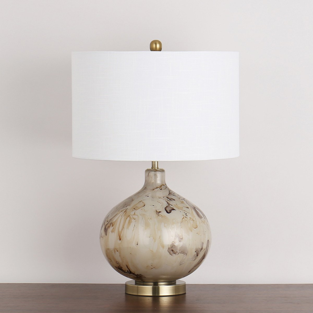 The Koma Table Lamp (64cm) offers warm ambient lighting and contemporary elegance with its sleek glass and metal base and straight round white shade.