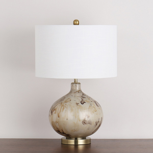 The Koma Table Lamp (64cm) offers warm ambient lighting and contemporary elegance with its sleek glass and metal base and straight round white shade.