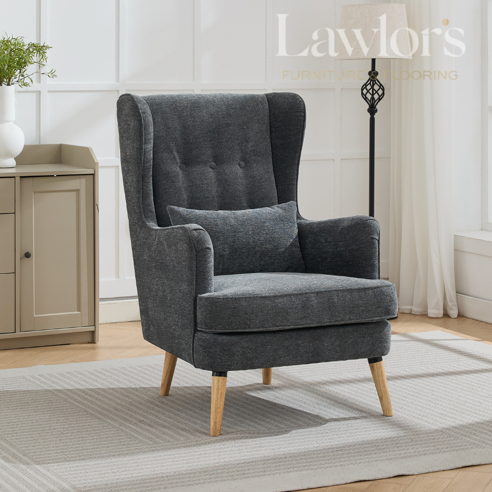 Grey armchair with wooden legs in a room setting