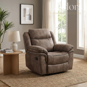 Brown recliner chair in a living room setting with a side table and lamp.