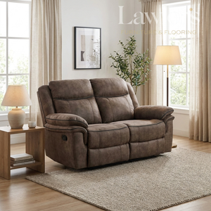 Brown 2 seater recliner sofa in a living room setting with a lamp and plant.