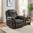 Grey leather recliner chair in a living room setting with a lamp, books, and plant.