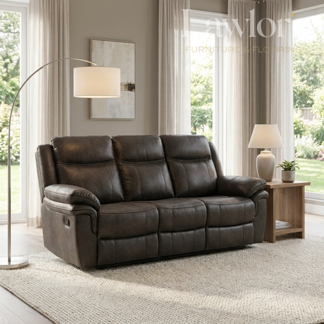 Grey leather 3 seater sofa in a living room setting with a lamp and window.