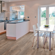 The Macro Oak Brown Laminate Flooring 12mm with AC5 rating, long planks for a stylish look and5G click install, compatible with underfloor heating.