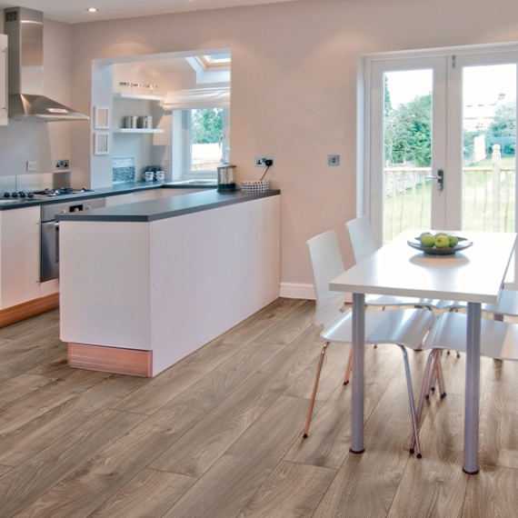 The Macro Oak Brown Laminate Flooring 12mm with AC5 rating, long planks for a stylish look and5G click install, compatible with underfloor heating.