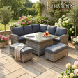 Outdoor garden furniture patio set with cushions and a table in a garden setting.