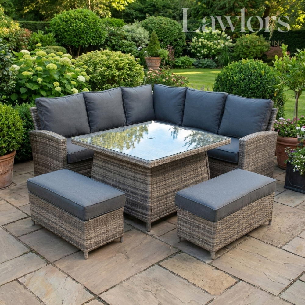 Outdoor garden furniture patio set with gray cushions on a stone patio