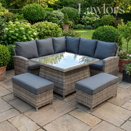 Outdoor garden furniture patio set with gray cushions on a stone patio