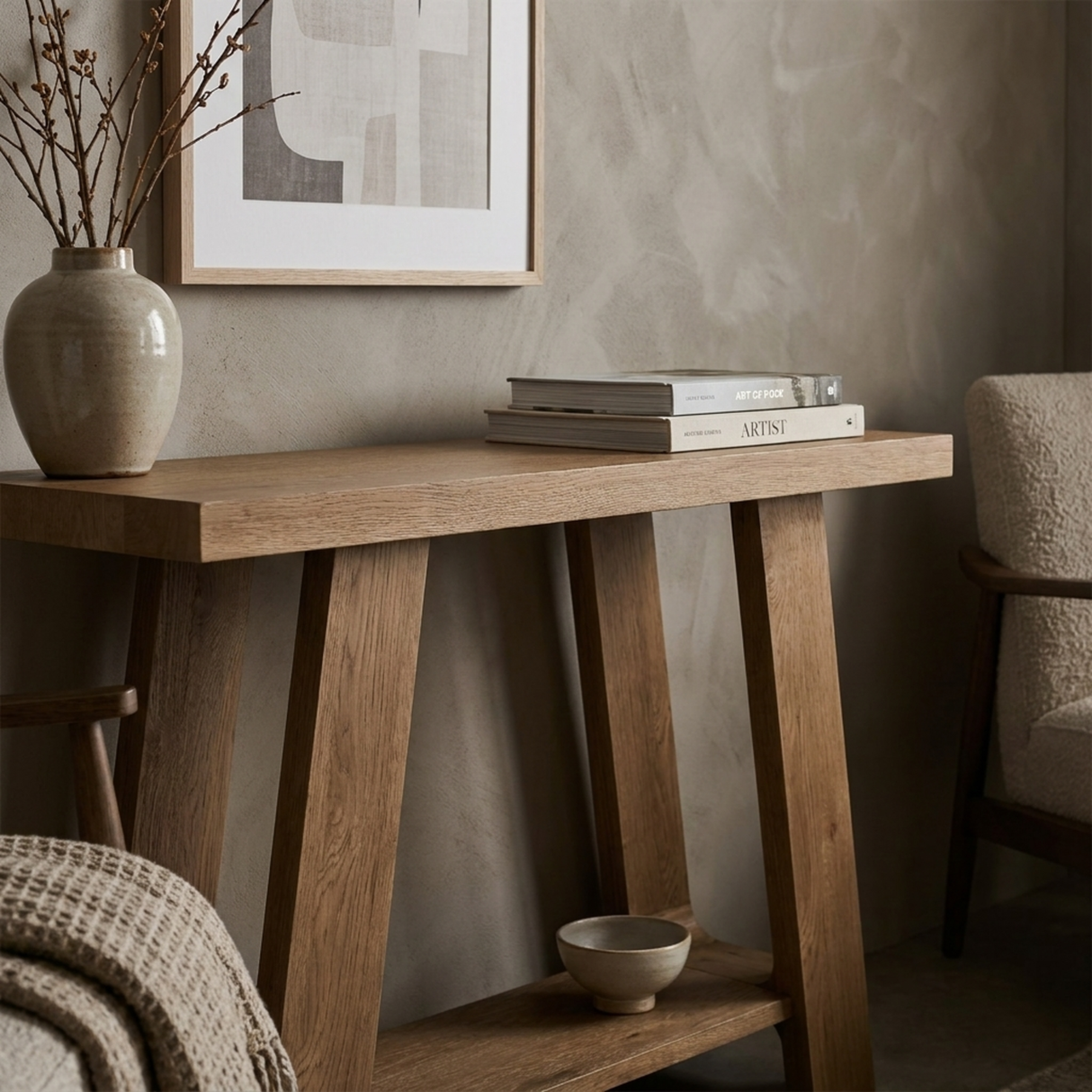 Wooden console table with decorative items against a neutral wall.