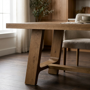 Wooden dining table with a chair in a softly lit room