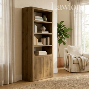 Wooden bookshelf in a living room with a plant and chair, featuring the Lawlor Home & Living logo.