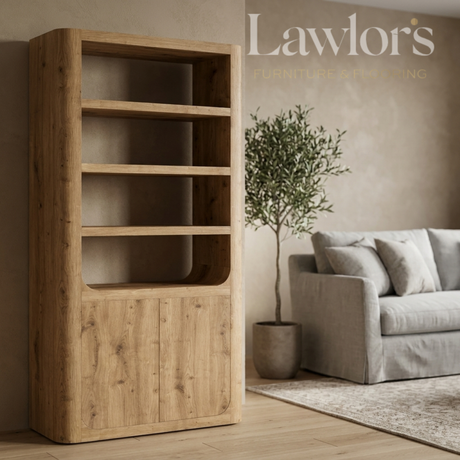 Wooden bookshelf in a living room with a gray sofa and a plant, featuring Lawlor's branding.