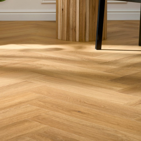 The Menor Oak Herringbone SPC Flooring features a timeless oak design, suitable for underfloor heating, Titanium Nano finish and a 25 year warranty