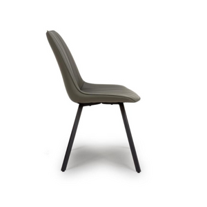 The Miro Chair in Tan & Truffle features faux leather and black metal legs that is elegant and easy to clean, enhancing any dining room experience