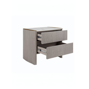 The Mondello 2 Drawer Bedside Table in Washed Oak features a luxurious sintered stone top, stainless steel accents and ample storage for a modern bedroom