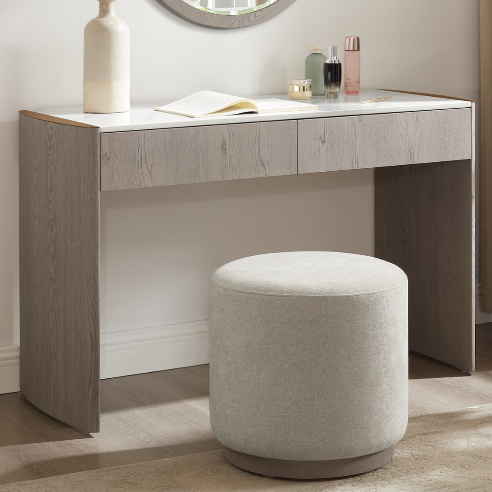 The Mondello 2 Drawer Dressing Table in Washed Oak features a luxurious sintered stone top, sleek steel accents and storage for a stylish practical bedroom