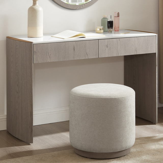 The Mondello 2 Drawer Dressing Table in Washed Oak features a luxurious sintered stone top, sleek steel accents and storage for a stylish practical bedroom