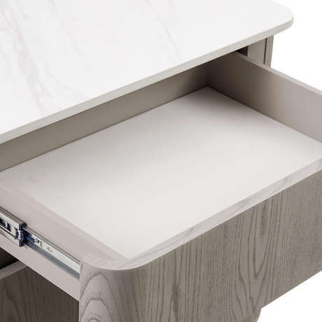 The Mondello 5 Drawer Dressing Table in Washed Oak features a sintered stone top, adjustable width and ample storage where luxury meets versatility