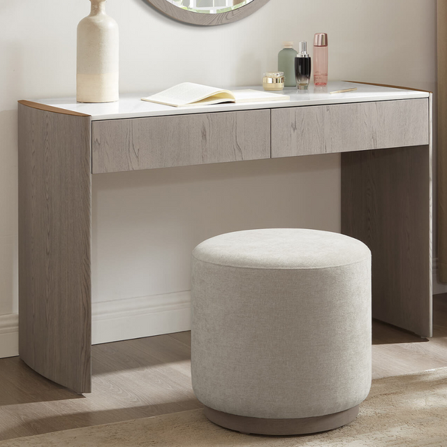 The Mondello Dressing Stool in Cream features soft upholstery, a sturdy wooden base and sleek design for an elegant and practical addition to any bedroom