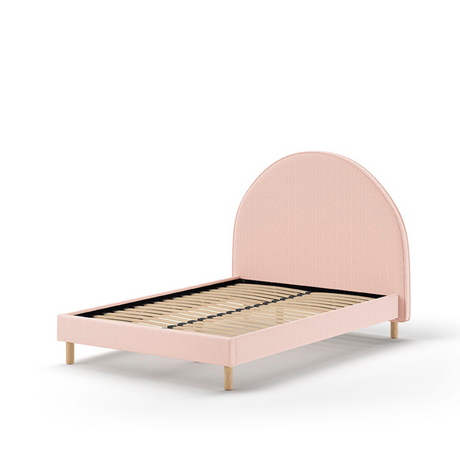 The Moon Kids Bed 140 x 200cm in Pink Boucle features a rounded headboard, soft upholstery and durable frame that is both cozy and stylish for any child