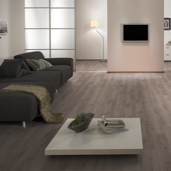 The Mountain Oak Grey Laminate Flooring 12mm features AC5 rated, long planks for a chic look and 5G installation compatible with underfloor heating.