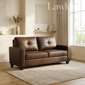 A brown leather loveseat sofa in a styled living room setting with beige walls, a window, curtains, and a light rug.