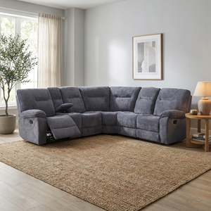 Dark grey sectional corner sofa in a living room with a rug and decor