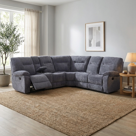 Dark grey sectional corner sofa in a living room with a rug and decor