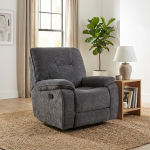Dark grey recliner chair in a living room setting with a plant and bookshelf.