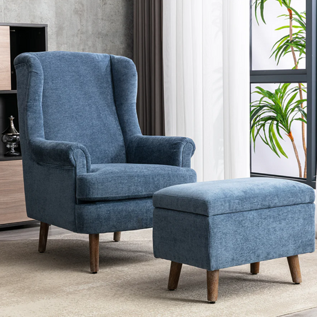 The Nina Armchair in Denim Blue features upholstered soft chenille fabric & is supported by dark wooden tapered legs.