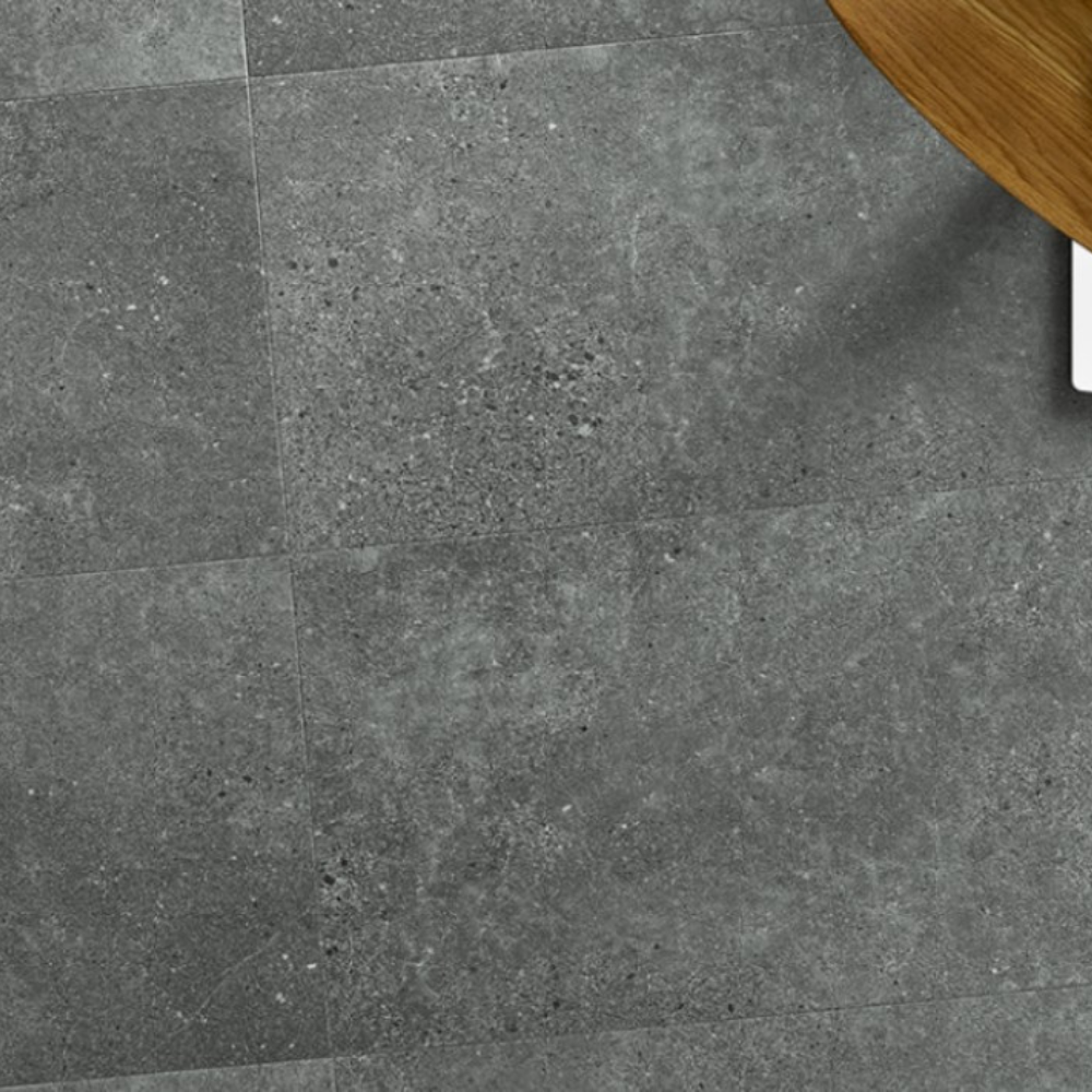 The Ninaventura Graphite Tile SPC Flooring features sleek tile design, waterproof mineral core, Titanium Nano finish and 25 year warranty