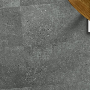 The Ninaventura Graphite Tile SPC Flooring features sleek tile design, waterproof mineral core, Titanium Nano finish and 25 year warranty
