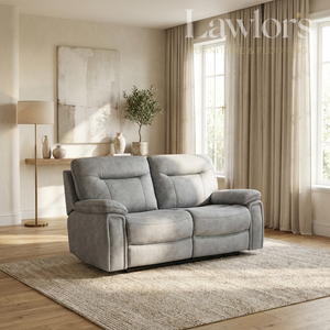 A light gray upholstered reclining loveseat sofa placed in a bright, modern living room with beige curtains, wood flooring, a rug, and wall decor.