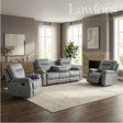 A gray upholstered living room furniture set in a staged modern living room, including a recliner, a three-seat sofa, and a matching recliner, with a large light rug, wood floors, windows, and wall art. 
