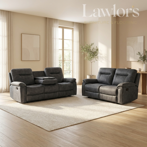 A dark gray two-piece recliner set consisting of a loveseat and a matching single-seater chair, styled in a modern, sunlit living room with beige walls, a light rug, and wood floors.