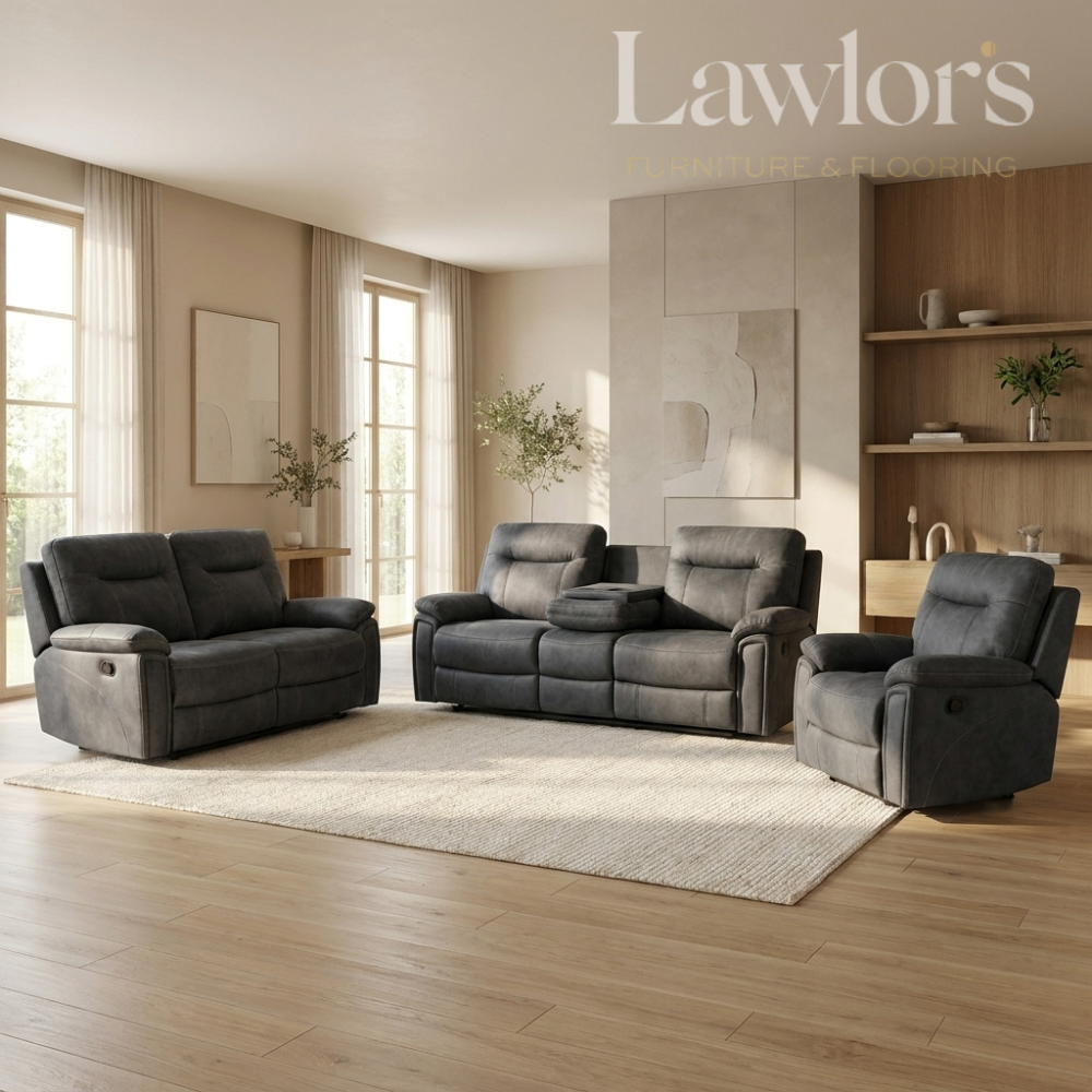 A modern living room furniture set by Lawlor's, including a dark gray reclining loveseat, a matching reclining armchair, and a reclining sofa, arranged on a light beige rug over light wood flooring.