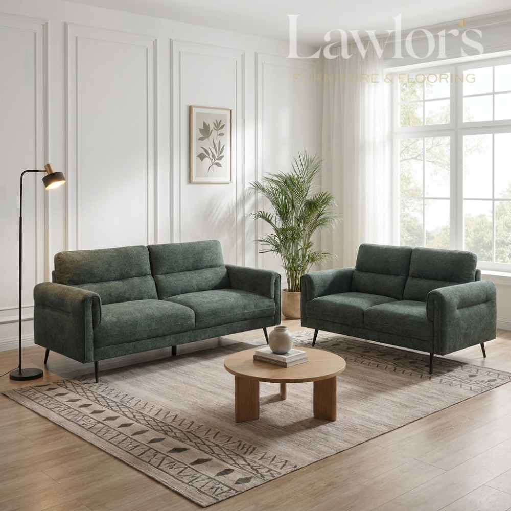 Green 3+2 sofa set in a living room with a coffee table and decorative elements.