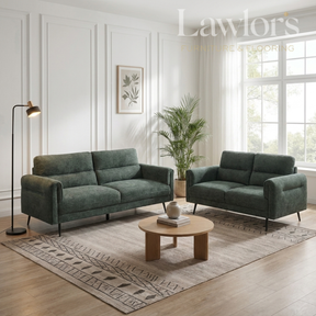 Green 3+2 sofa set in a living room with a coffee table and decorative elements.
