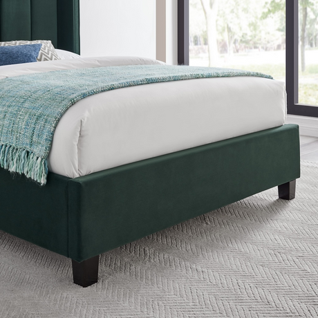 The Palmer Bed in Emerald Green in 4ft6 Double and 5ft King features a 134cm headboard, recycled velvet and winged design, where eco-friendly meets luxury