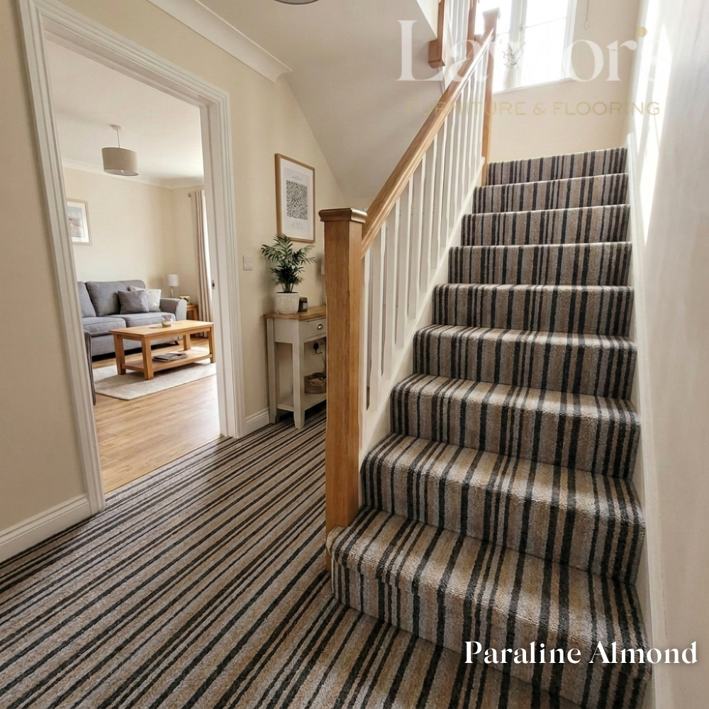 Staircase with striped carpet in a home interior, featuring a mirror and furniture.