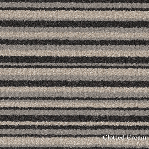Patterned fabric with black and beige stripes labeled 'Clotted Cream'.