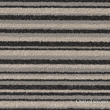 Patterned fabric with black and beige stripes labeled 'Clotted Cream'.
