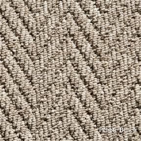 Close-up of textured beige carpet with 'Pebble Beach' label