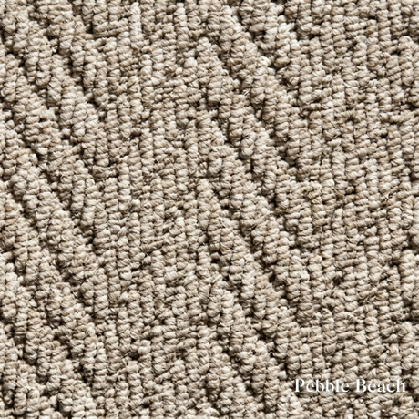 Close-up of textured beige carpet with 'Pebble Beach' label
