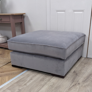 The Pillow Top Footstool in Grey with plush cushioned top, versatile design and durable fabric, perfect as a footrest, extra seat or casual coffee table